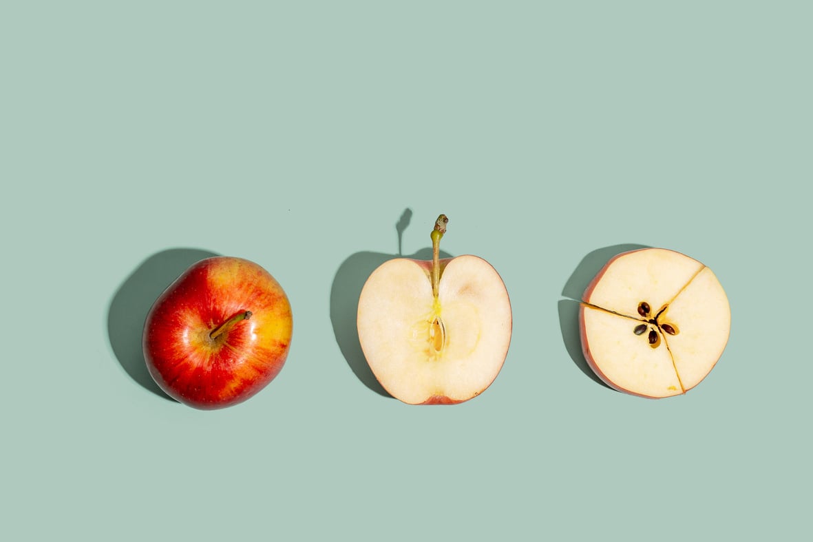 Sliced Apples on Green Background